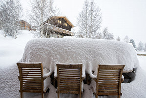 Fresh drop of snow covering ooutside table