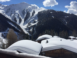 Snow covered roof tops and mountains